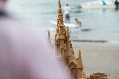 Close-up of wooden posts on beach