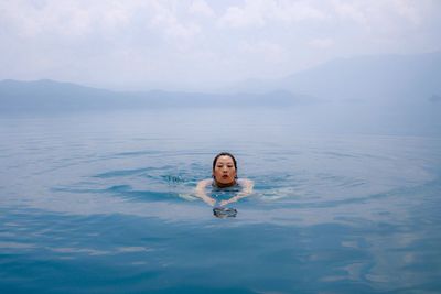 Portrait of woman swimming in water