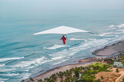 Person paragliding in sea