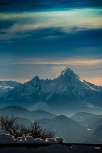 Scenic view of snowcapped mountains against sky during sunset