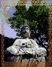 Low angle view of statue against trees