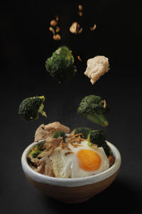 Close-up of salad in bowl against black background