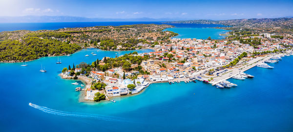 High angle view of city by sea against sky