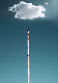 Low angle view of industrial tower against sky