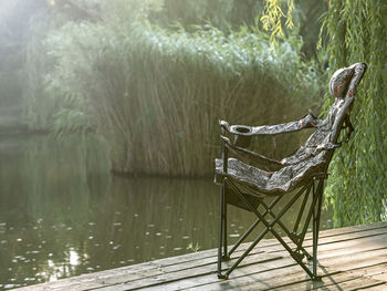 View of chair by lake