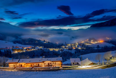 Mountain village after snowfall at sunset