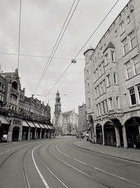 Street amidst buildings in city against sky