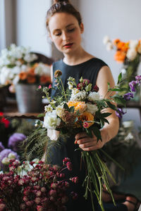 Young woman holding flower bouquet