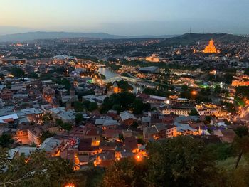 High angle view of illuminated buildings in city at night