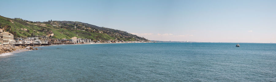 Scenic view of sea against blue sky