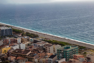 High angle view of sea and buildings in city