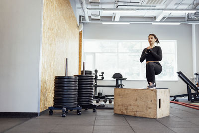 Portrait of young woman exercising in gym