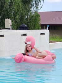 Happy teen female in swimming pool