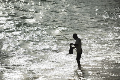 Full length of man fishing in sea