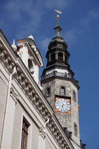 Low angle view of modern building against cloudy sky