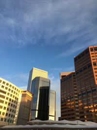 Low angle view of modern buildings against sky in city