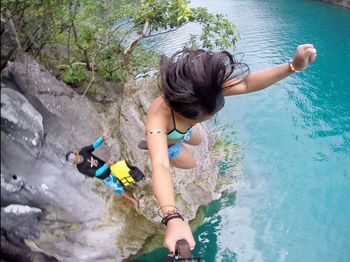 Rear view of girl enjoying in river