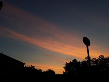 Low angle view of silhouette trees against sky at sunset