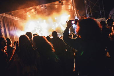 People enjoying music concert at night