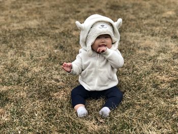 Full length of cute baby girl sitting on playground