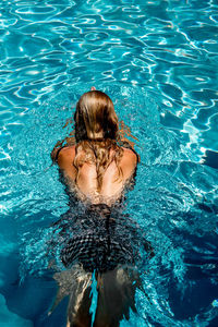 High angle view of woman swimming in pool