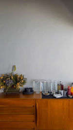 View of glass table against wall at home