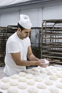 Rear view of man working at store