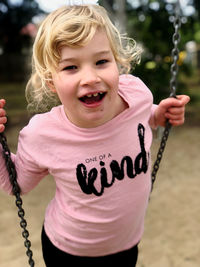 Portrait of a girl on a swing