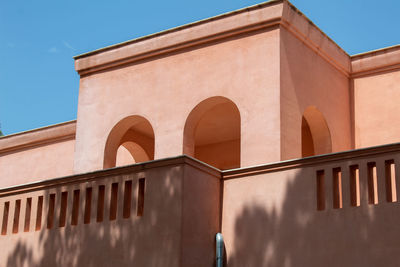 Low angle view of building against clear blue sky