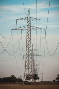 Low angle view of electricity pylon against sky