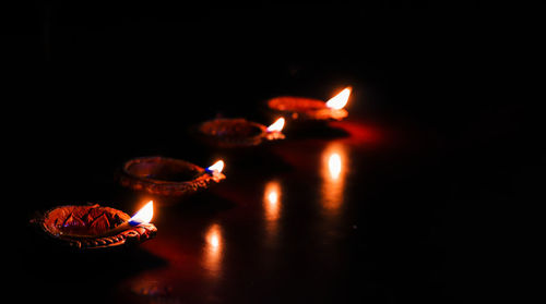 Lit candles in the dark