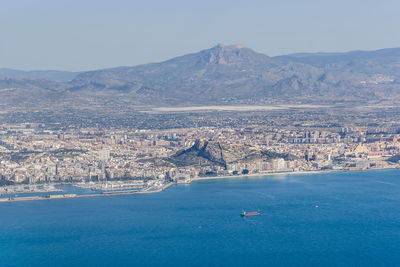 Scenic view of sea by city against sky