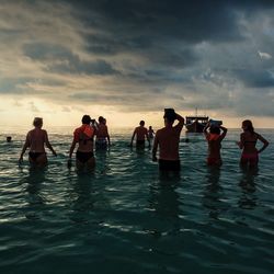 People on beach at sunset