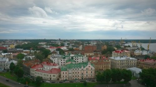 Cityscape against cloudy sky