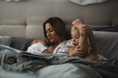 Mother with kids in bed