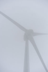 Low angle view of wind turbine against sky