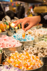 Person holding ice cream for sale at market