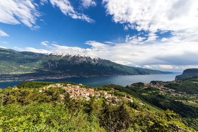 Scenic view of sea and mountains against sky