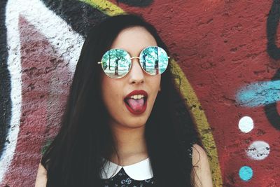 Portrait of young woman wearing sunglasses