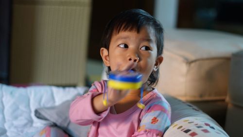 Boy playing with toy at home