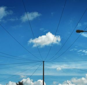 Low angle view of cables against blue sky