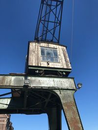 Low angle view of old tower against clear blue sky