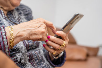 Midsection of woman using mobile phone