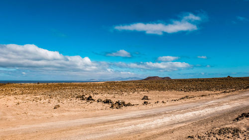 Scenic view of landscape against blue sky