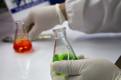 Cropped image of hand holding conical flask