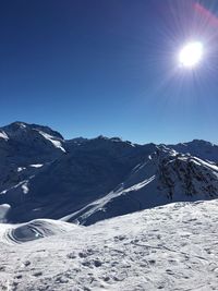 Scenic view of mountain range against blue sky