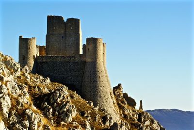 Low angle view of built structure against clear blue sky