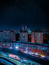 Illuminated buildings in city at night