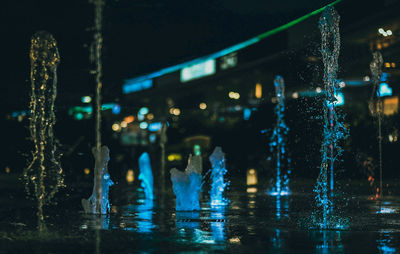 Illuminated wet glass at night