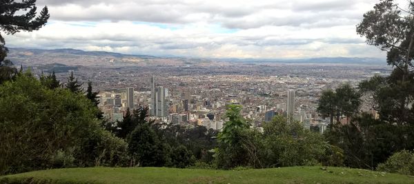 Panoramic view of trees and buildings against sky